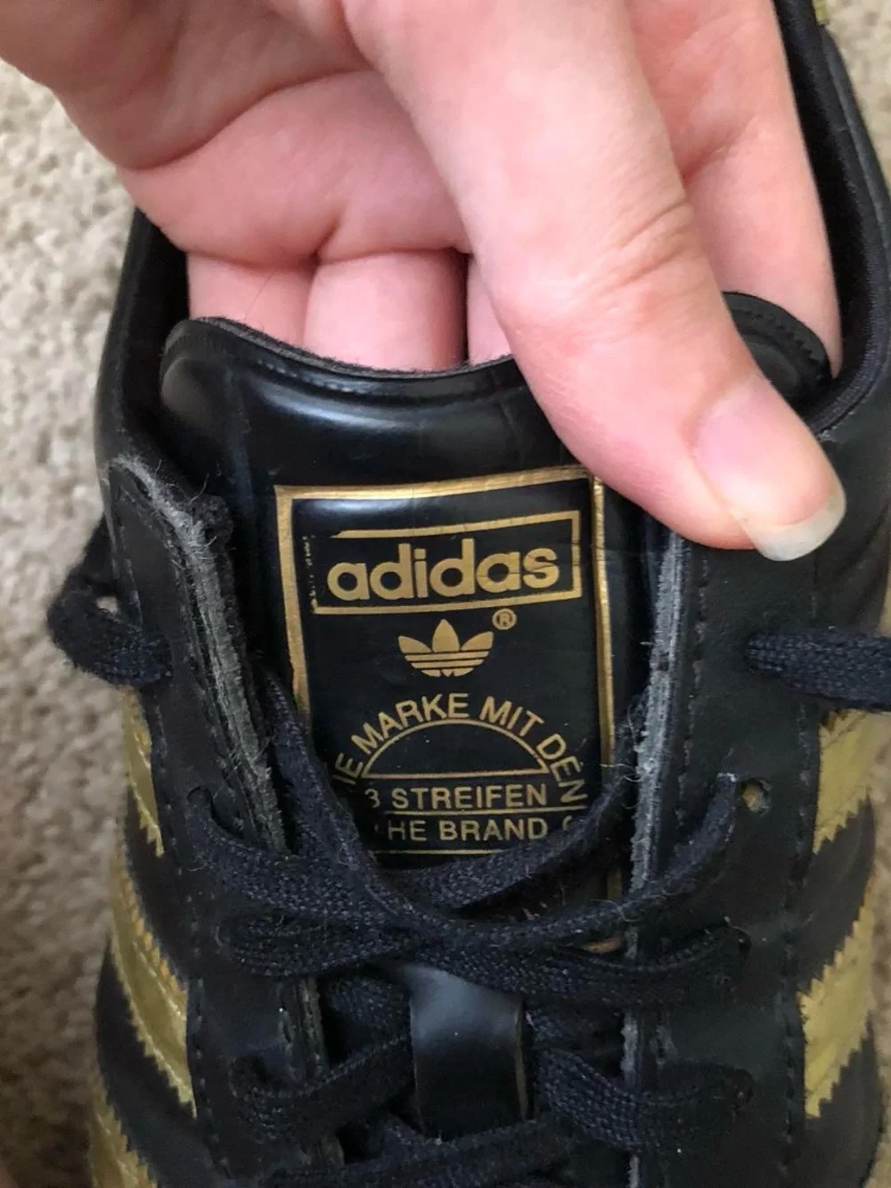 adidas Women’s Black Sneakers with Gold Stripes
